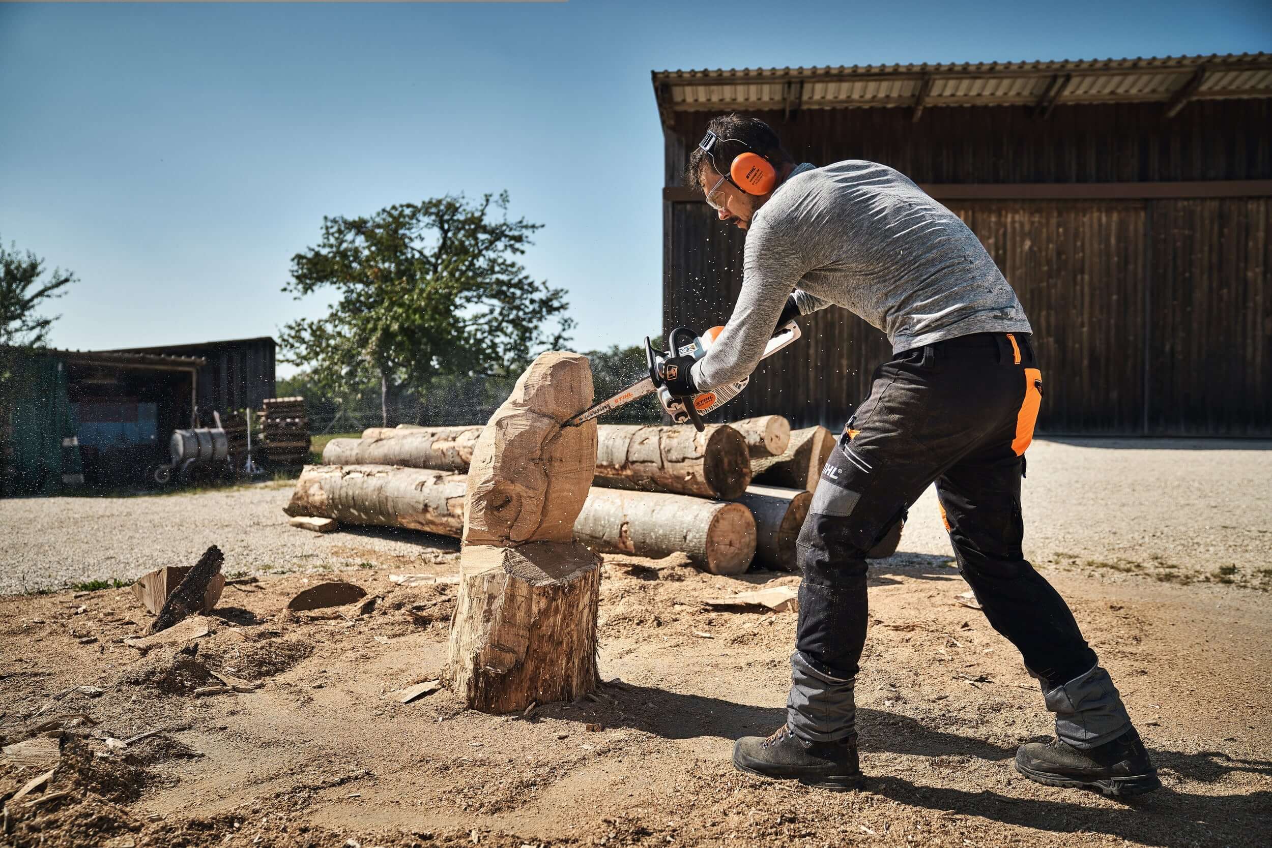 STIHL guidebar carving a owl out of a wooden log